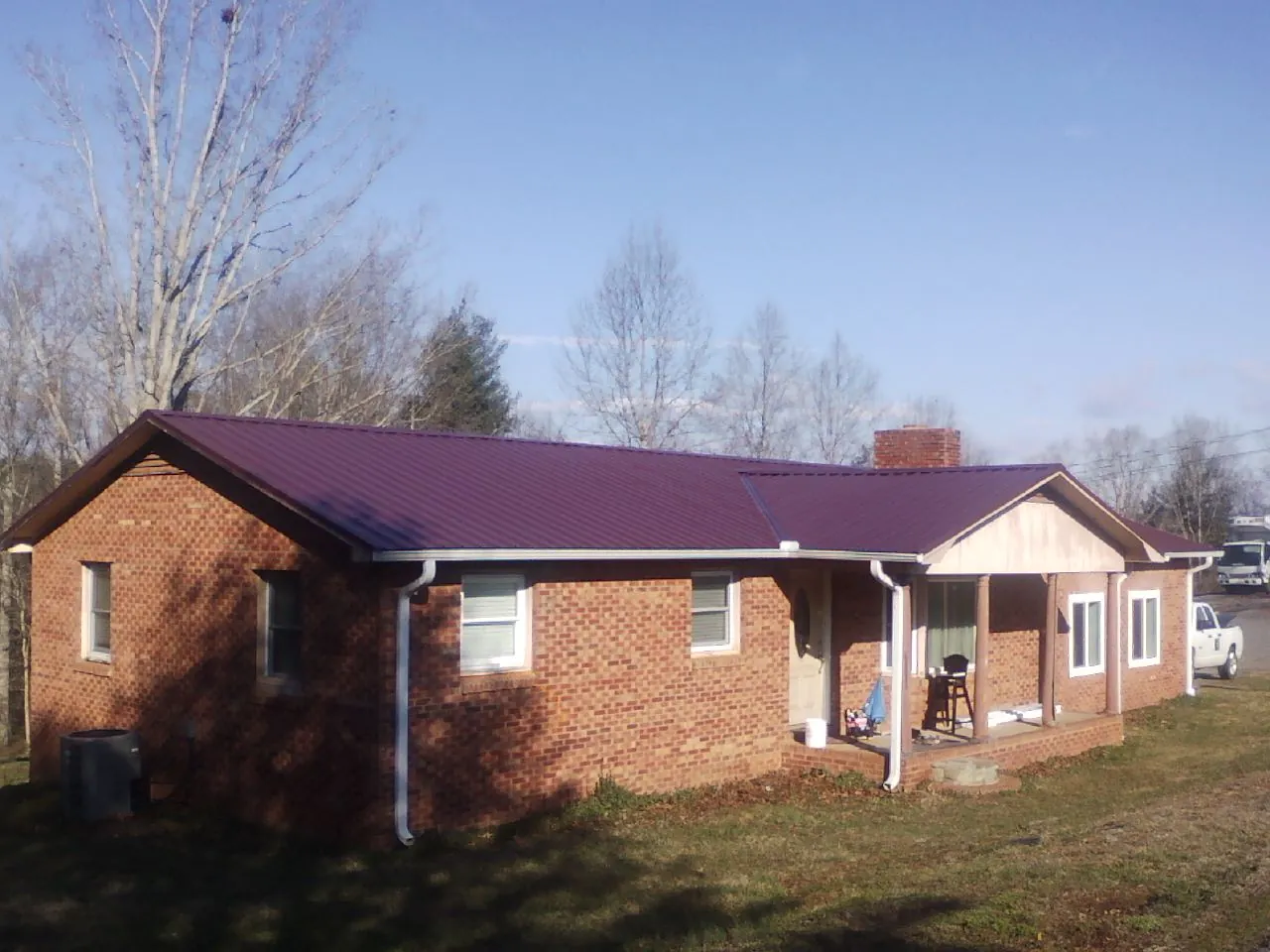Burgundy metal roof on a brick ranch home with a new addition in Escalon