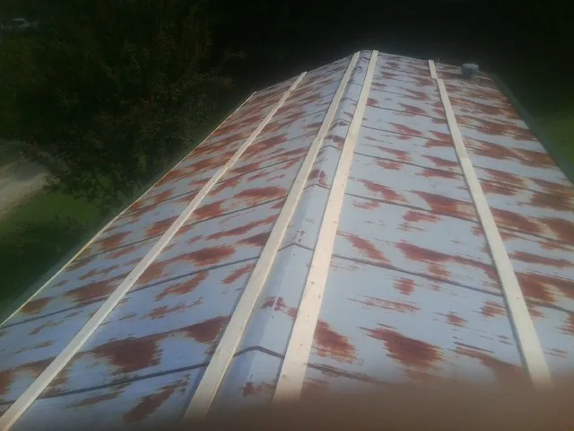 Rusted metal roof panels with new wood purlins before replacement — Storm Damage Roof Repair in Escalon by Roofing Brothers